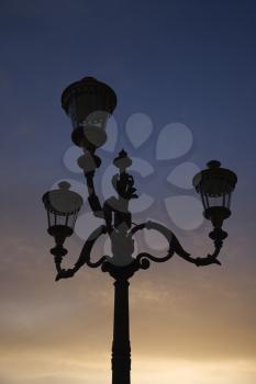 Royalty Free Photo of a Streetlamp With the Sunset Sky in Background in Rome, Italy