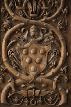 Royalty Free Photo of a Close-up Wood Carving of Papal Coat of Arms in the Vatican Museum, Rome, Italy