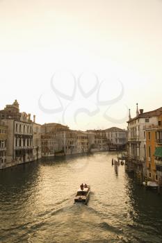 Royalty Free Photo of Buildings and Boat on a Canal in Venice, Italy