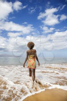 Royalty Free Photo of a Woman Walking Towards the Ocean