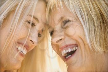 Royalty Free Photo of a Mother and Daughter Smiling and Laughing