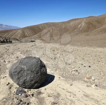 Royalty Free Photo of a Boulder in a Barren Landscape in Death Valley National Park