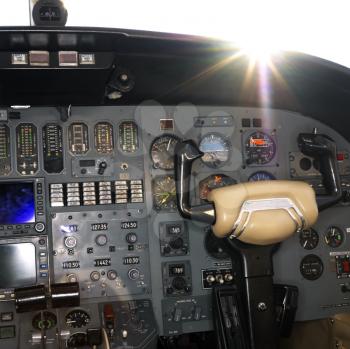 Royalty Free Photo of an Interior Shot of an Airplane With the Sun Peeking Over the Dashboard