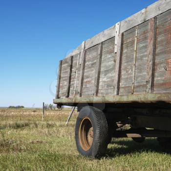 Royalty Free Photo of the Back End of an Old Wooden Trailer in a Field