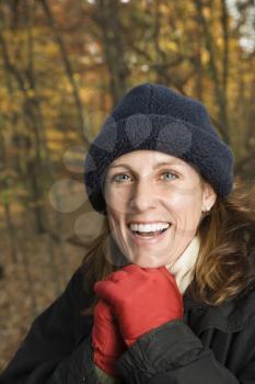 Royalty Free Photo of a Smiling Woman Standing in a Forest