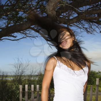 Royalty Free Photo of a Woman Swinging Her Hair and Screaming
