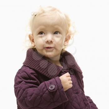 Portrait of young Caucasian female toddler wearing a purple coat.