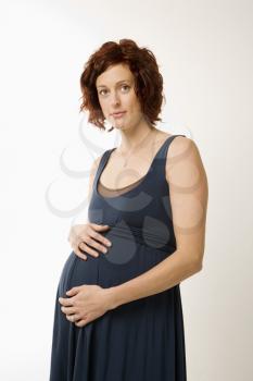 Royalty Free Photo of a Pregnant Woman With Hands on Her Belly 
