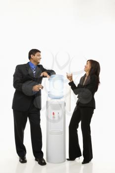Royalty Free Photo of Businesspeople Standing Talking at a Water Cooler 