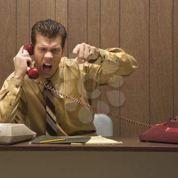 Royalty Free Photo of
a Businessman Shouting into a Telephone
