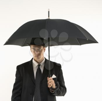 Royalty Free Photo of a Businessman Wearing a Fedora and Holding an Umbrella 