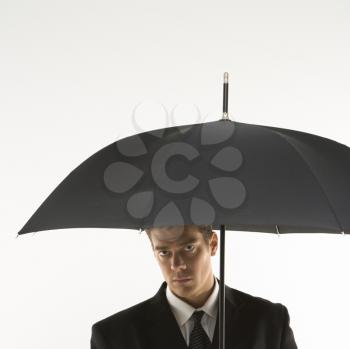 Royalty Free Photo of a Businessman Holding an Umbrella