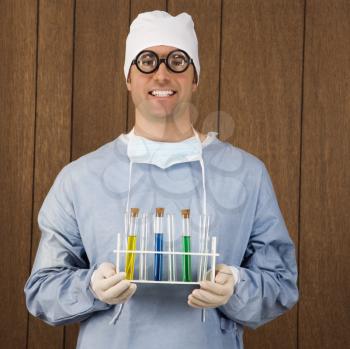 Royalty Free Photo of a Male Surgeon Wearing Thick Glasses and Holding a Test Tube Tray