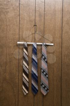 Royalty Free Photo of Three Retro Ties Hanging on a Hanger