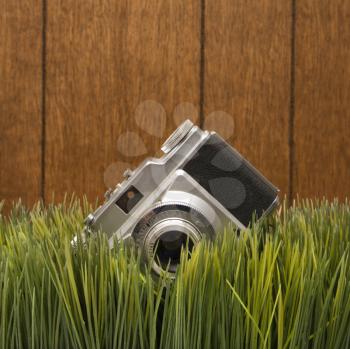 Royalty Free Photo of a Studio Shot of a Vintage Camera With Wood Paneling in the Background