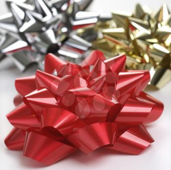 Royalty Free Photo of a Still Life of a Big Shiny Red, Gold and Silver Christmas Bows