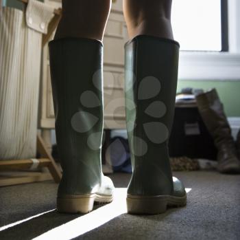 Royalty Free Photo of a Woman's Legs Wearing Green Rubber Boots