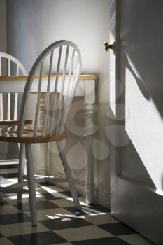 Royalty Free Photo of a Sunlight Lit Kitchen With a Dinette and Checkerboard Tiled Floor