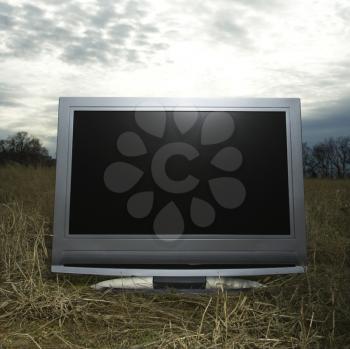 Royalty Free Photo of 
Flat Panel Television Set in a Grassy Field