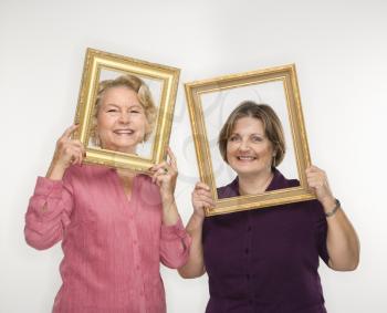 Royalty Free Photo of Women Holding Frames Around Their Faces