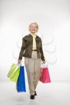 Royalty Free Photo of a Woman Holding Gift Bags Smiling