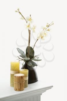 Royalty Free Photo of a Still Life of Yellow Candles and White Orchids