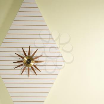 Retro star-shaped clock hanging on wall.