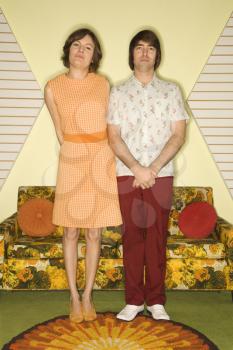 Royalty Free Photo of a Couple Standing in a Room Decorated With Vintage Furniture