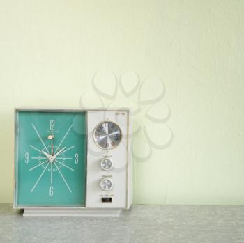 Still life of vintage clock radio with turquois face.