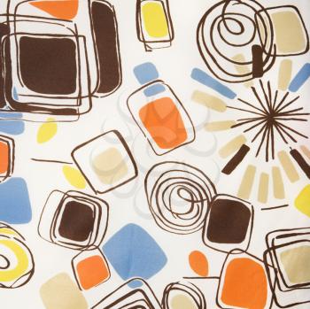 Royalty Free Photo of a Close-Up of a Vintage Fabric With Abstract Shapes and Swirls Printed on Polyester