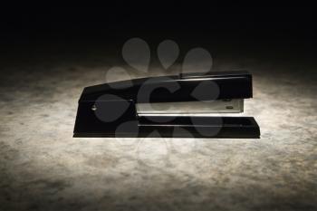 Royalty Free Photo of a Black Stapler With Black Vignette