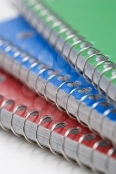 Royalty Free Photo of a Close-up of Three Spiral Bound Notebooks Stacked Up