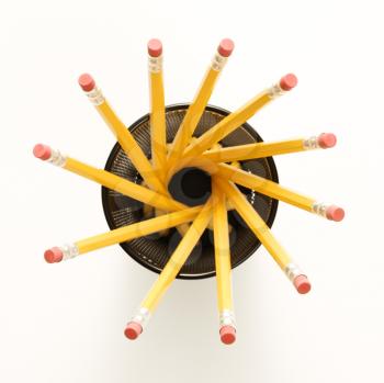 Top view of group of pencils in pencil holder arranged in a spiral shape.