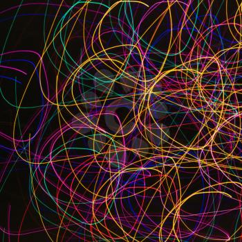 Multicolored lights forming abstract circular pattern from motion blur.