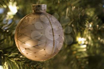 Royalty Free Photo of a Close-up of a Gold Ornament Hanging on a Christmas Tree