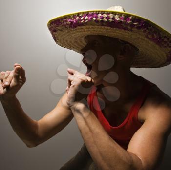 Portrait of a Mid-adult Caucasian male wearing sombrero snapping fingers.