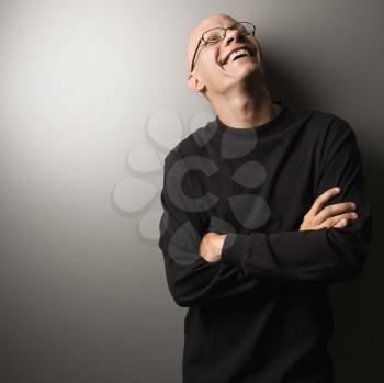Royalty Free Photo of a Male With Crossed Arms Smiling