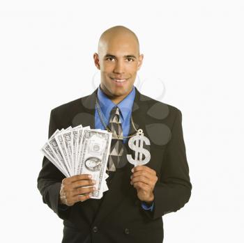 Royalty Free Photo of a Businessman Wearing a Necklace With a Money Sign and Holding Cash