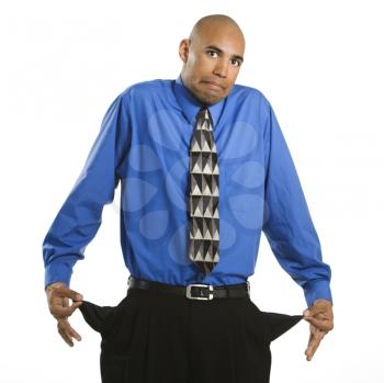 Royalty Free Photo of a Man in a Suit Pulling Out Empty Pockets and Shrugging