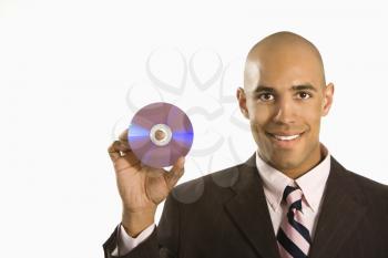 Royalty Free Photo of a Man Smiling Holding Out a Compact Disc