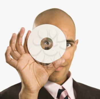 Royalty Free Photo of a Man Holding a CD Over His Face