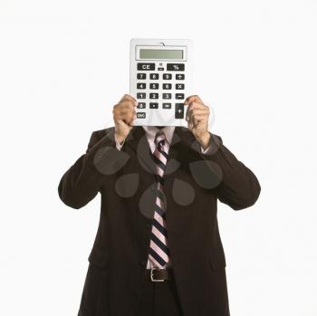 Royalty Free Photo of an African American Man Holding an Over-sized Calculator Over His Face