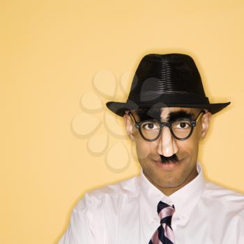 Royalty Free Photo of a Man Wearing a Groucho Mask Disguise