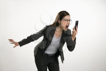Royalty Free Photo of a Professional Businesswoman Yelling into a Cellphone in Anger