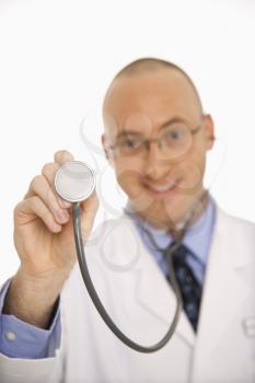 Royalty Free Photo of a Physician Holding Up a Stethoscope 