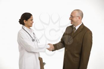 Royalty Free Photo of a Female Doctor Shaking Hands With a Businessman