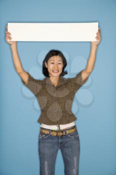 Royalty Free Photo of a Pretty Woman Holding a Blank Sign