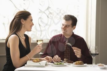 Royalty Free Photo of a Couple Dining in a Restaurant and Smiling