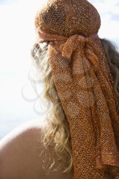 Royalty Free Photo of the Back of a Woman With Wavy Hair and Head Scarf
