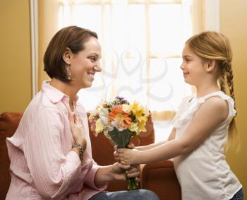 Royalty Free Photo of Girl Giving a Mother Flowers